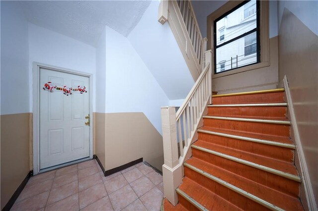 1830 81st St, Brooklyn, NY 11214 - interior space with baseboards, tile patterned flooring, and stairway