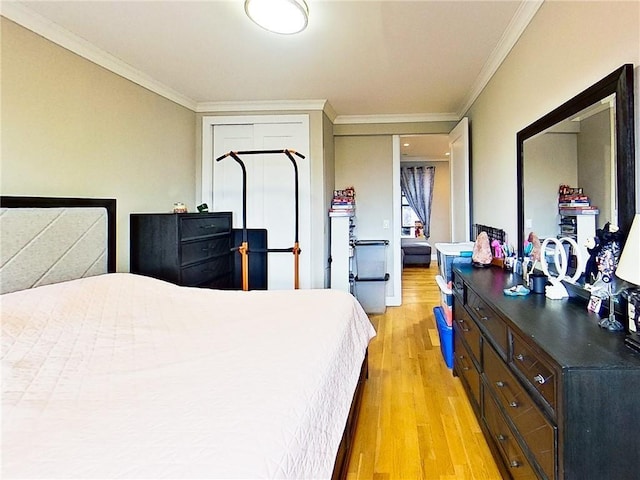 bedroom with ornamental molding and light hardwood / wood-style flooring