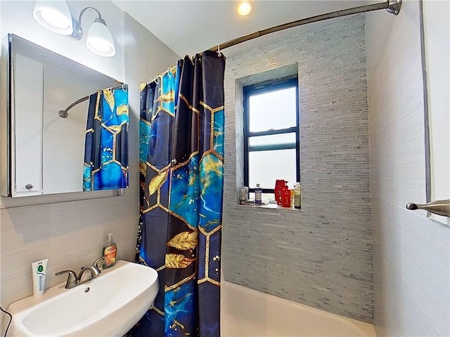 bathroom with sink and shower / bath combination with curtain