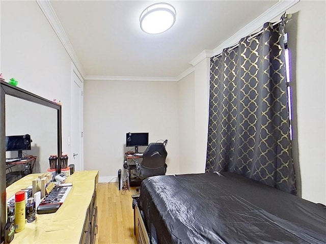 bedroom featuring ornamental molding and hardwood / wood-style floors