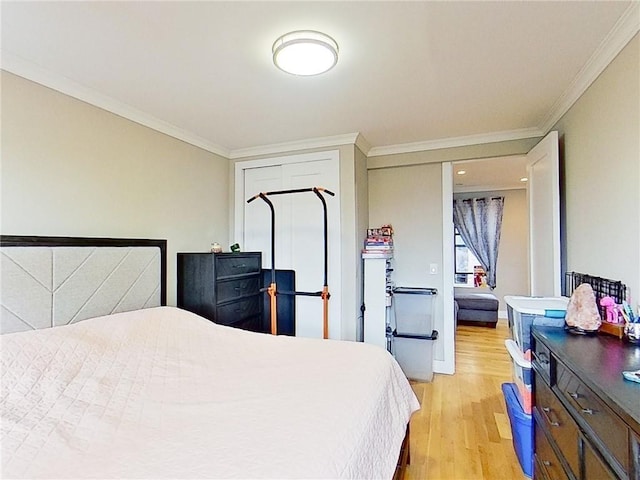 bedroom with light hardwood / wood-style floors and crown molding