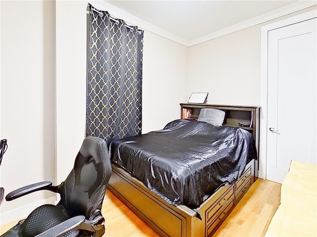 bedroom featuring light wood-type flooring and crown molding