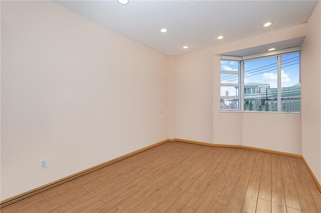 empty room with light hardwood / wood-style floors