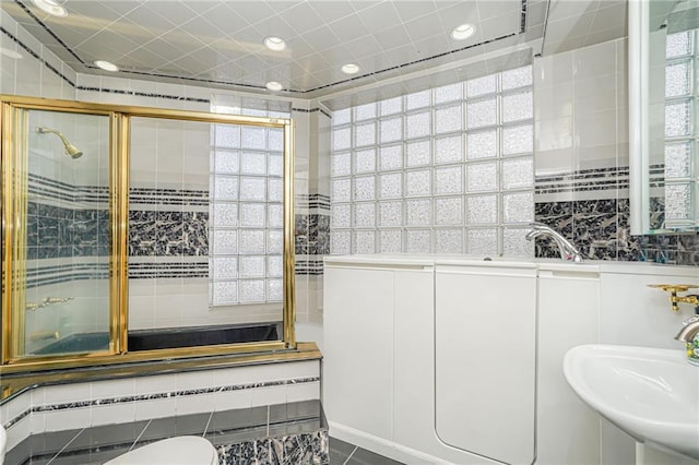 bathroom featuring sink and an enclosed shower