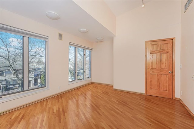 unfurnished room with wood-type flooring