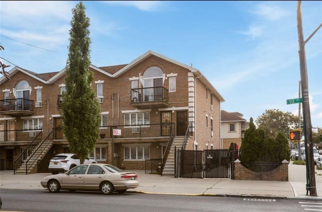 view of building exterior featuring fence and stairway