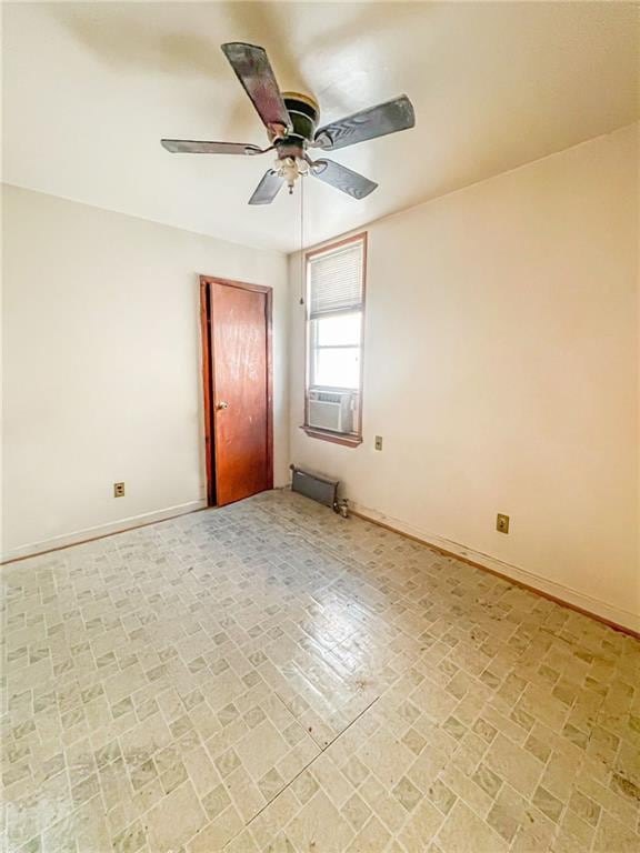 unfurnished room with ceiling fan and cooling unit