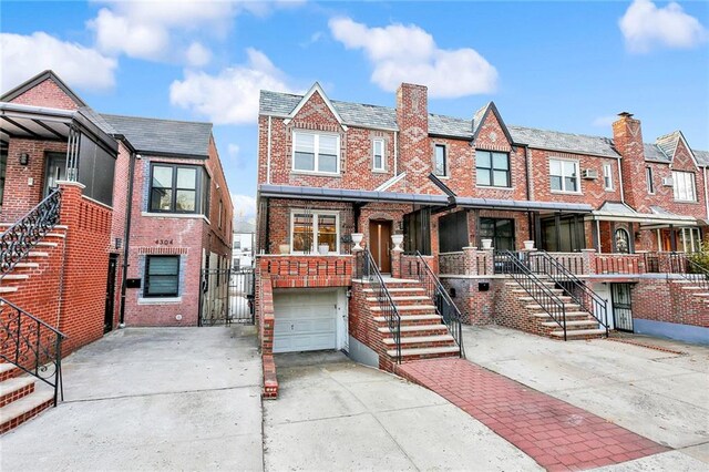 multi unit property featuring a garage and a porch