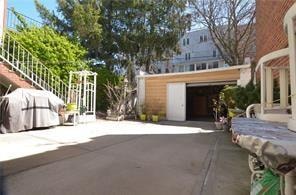 exterior space with an outdoor structure, grilling area, and a detached garage