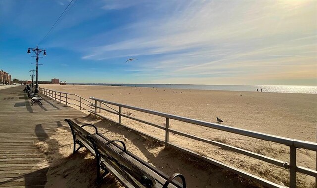 view of dock with a view of the beach and a water view