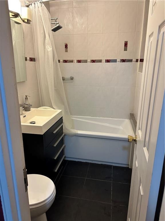 bathroom with shower / tub combo with curtain, vanity, toilet, and tile patterned floors