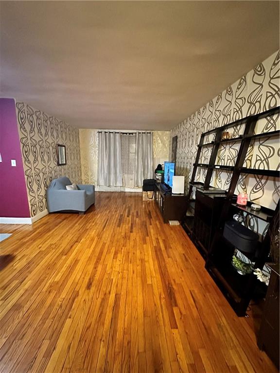 unfurnished living room featuring hardwood / wood-style flooring