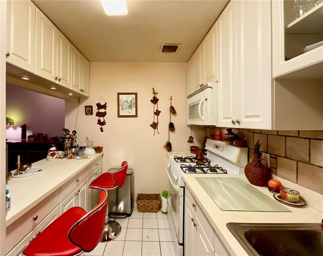 100 Oceana Dr W Unit 1G, Brooklyn, NY 11235 - kitchen featuring white appliances, light tile patterned floors, white cabinets, and light countertops