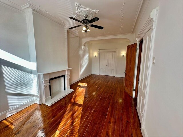 interior space with ornamental molding, baseboards, and hardwood / wood-style floors