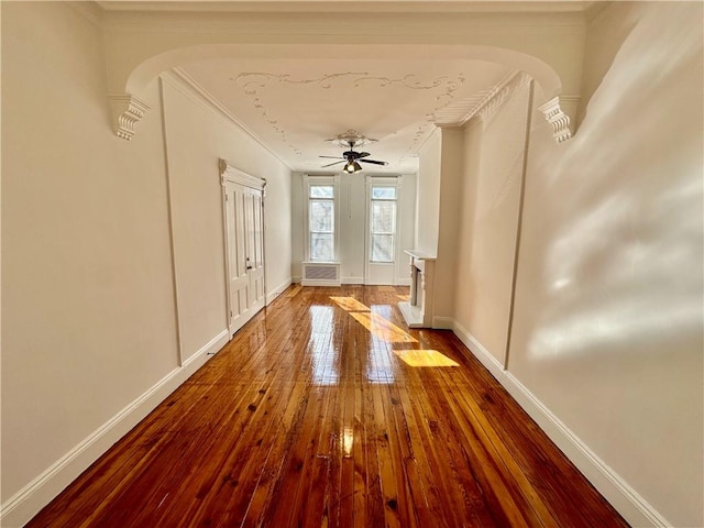 13 Windsor Pl, Brooklyn, NY 11215 - foyer entrance with ornamental molding, hardwood / wood-style flooring, arched walkways, baseboards, and a ceiling fan
