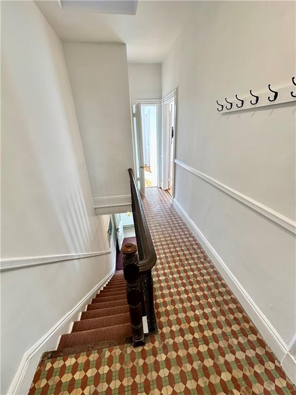 13 Windsor Pl, Brooklyn, NY 11215 - staircase with baseboards and carpet flooring