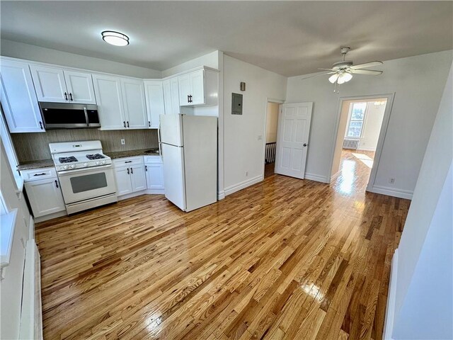 kitchen with ceiling fan, white cabinets, white appliances, and decorative backsplash