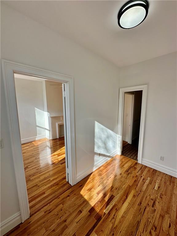 unfurnished room with wood-type flooring