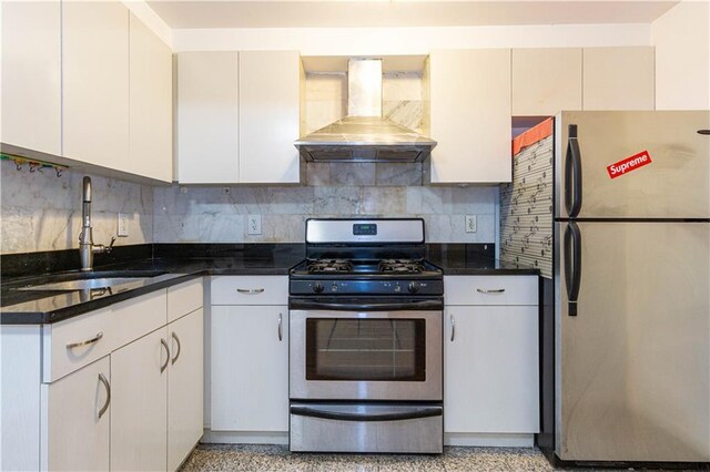 kitchen with sink, white cabinetry, appliances with stainless steel finishes, and wall chimney exhaust hood