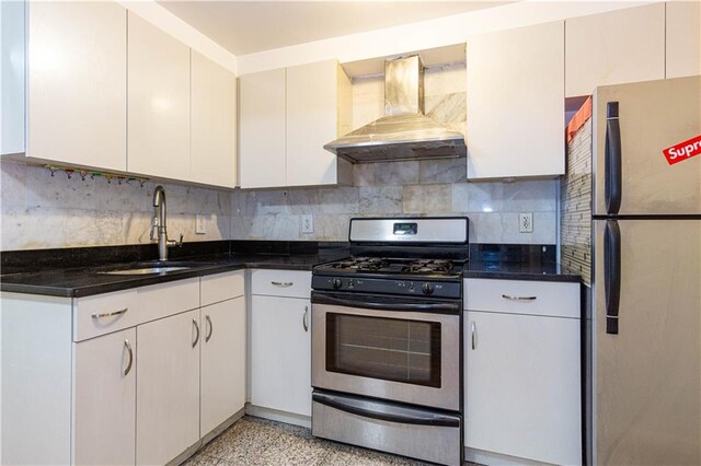 kitchen with white cabinetry, sink, wall chimney range hood, and appliances with stainless steel finishes