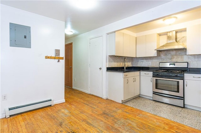 kitchen featuring backsplash, electric panel, stainless steel range with gas stovetop, baseboard heating, and wall chimney exhaust hood