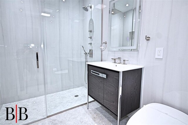 bathroom featuring toilet, vanity, and a walk in shower