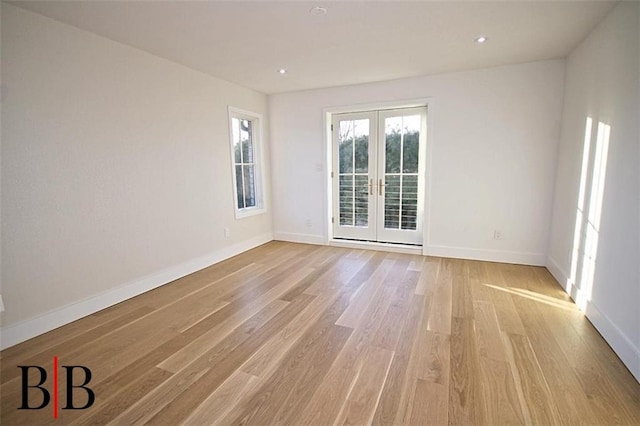 unfurnished room featuring light wood-type flooring, french doors, baseboards, and recessed lighting