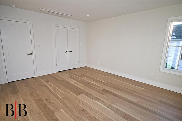 unfurnished bedroom featuring baseboards and light wood-style flooring
