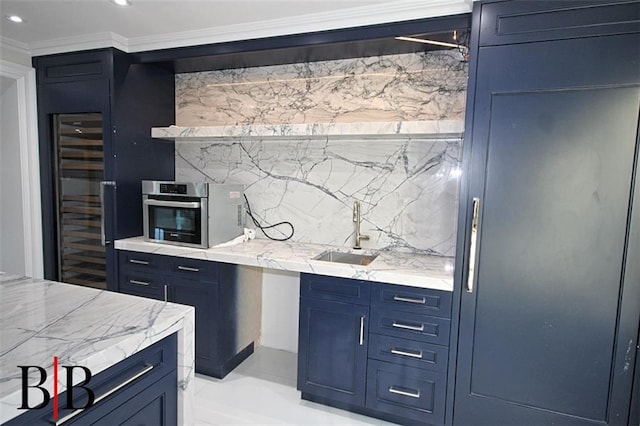 kitchen with crown molding, a sink, blue cabinetry, wine cooler, and backsplash