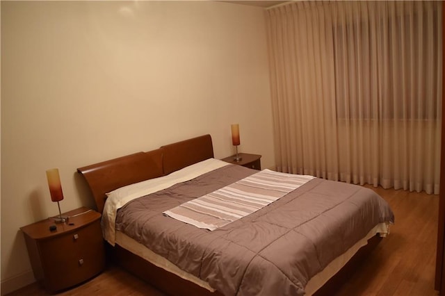 bedroom featuring wood finished floors