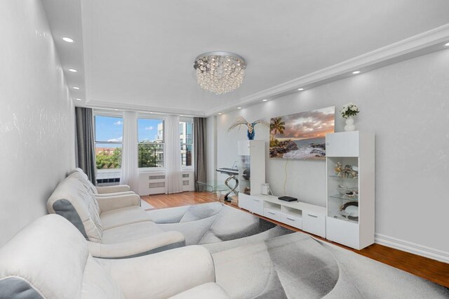 living room with an inviting chandelier and light hardwood / wood-style flooring