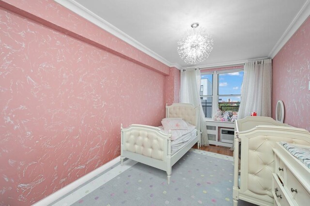 bedroom featuring crown molding and an inviting chandelier