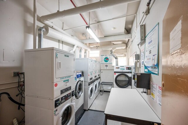 laundry room featuring stacked washer and dryer and washing machine and clothes dryer