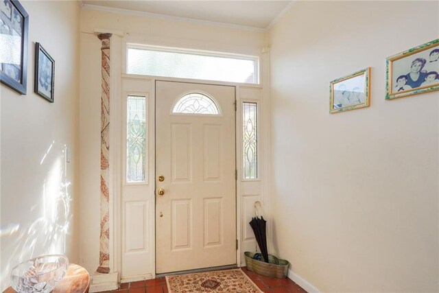 tiled entryway with ornamental molding