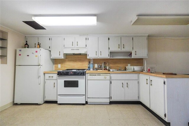 kitchen with backsplash, sink, white appliances, and white cabinets