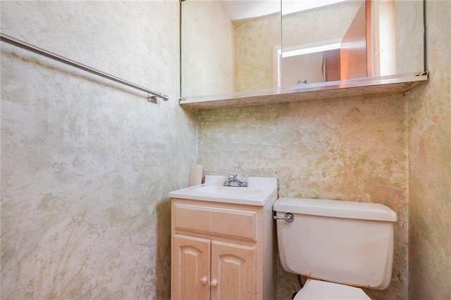 bathroom featuring toilet and vanity