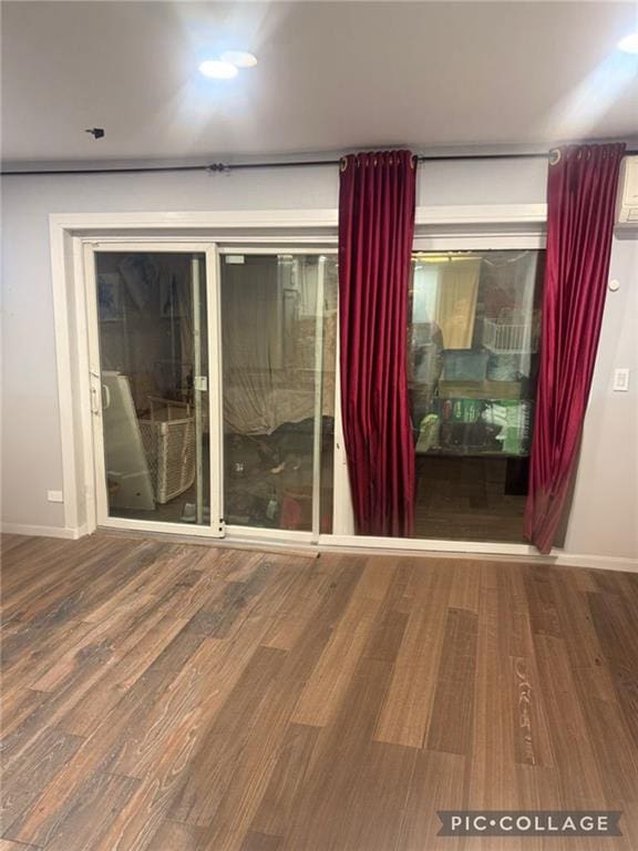 unfurnished room featuring wood finished floors and baseboards