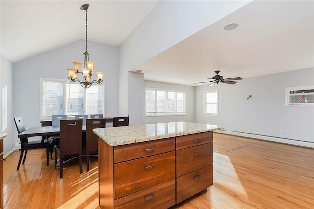 kitchen with vaulted ceiling, an AC wall unit, light wood-type flooring, brown cabinets, and pendant lighting