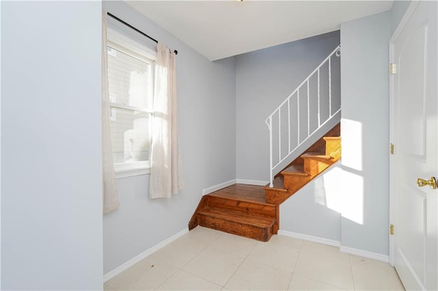 stairs with tile patterned flooring and baseboards