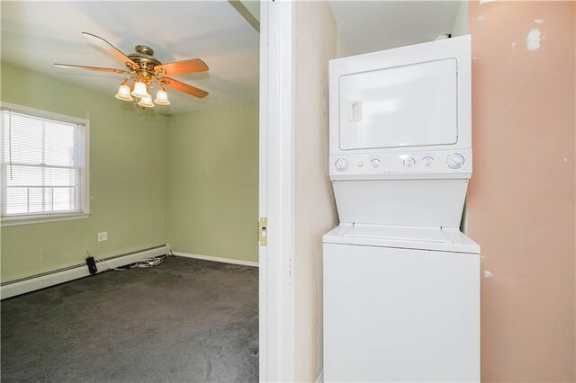 clothes washing area with ceiling fan, a baseboard radiator, laundry area, carpet floors, and stacked washing maching and dryer