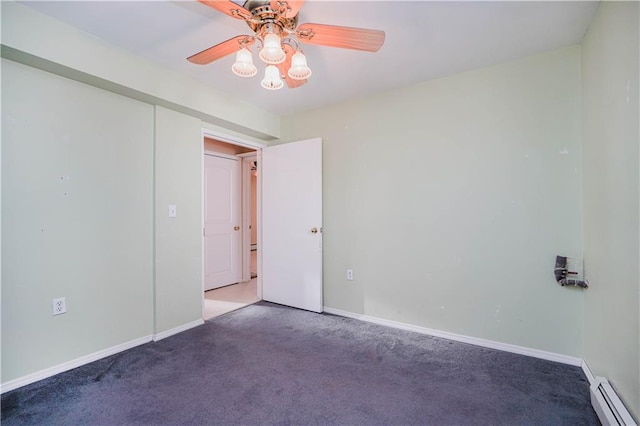 carpeted empty room with a baseboard heating unit, a ceiling fan, and baseboards