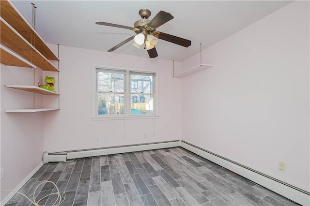 spare room with a baseboard radiator, ceiling fan, and wood finished floors