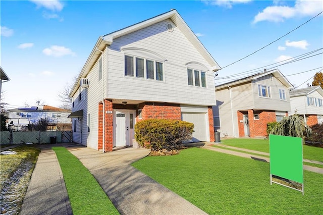 view of front of house featuring a garage, brick siding, a front lawn, and fence