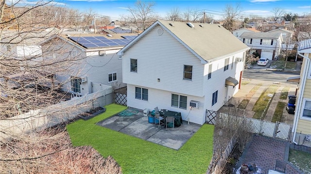 rear view of property featuring a patio, a yard, a fenced backyard, and a residential view