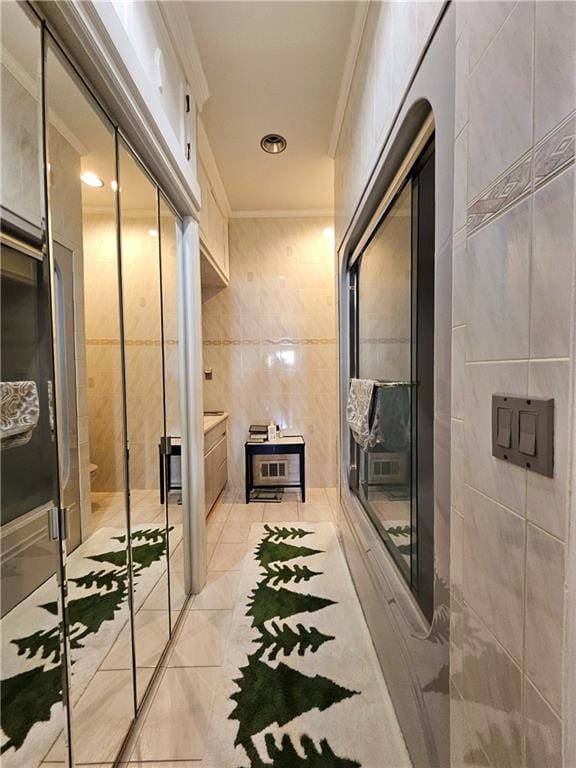 bathroom with tile walls and crown molding