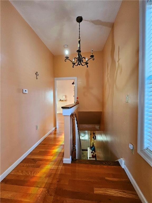 unfurnished dining area with a chandelier and hardwood / wood-style floors