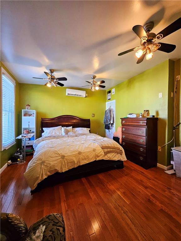 bedroom featuring ceiling fan and dark hardwood / wood-style floors