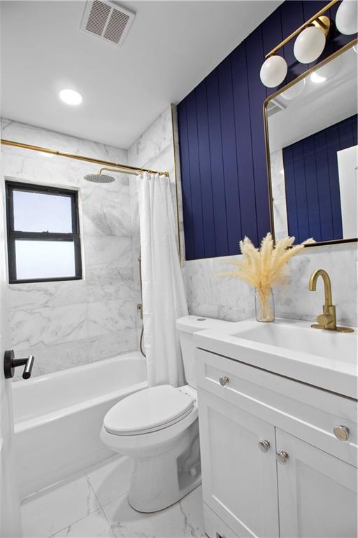 full bathroom with toilet, vanity, and shower / tub combo with curtain