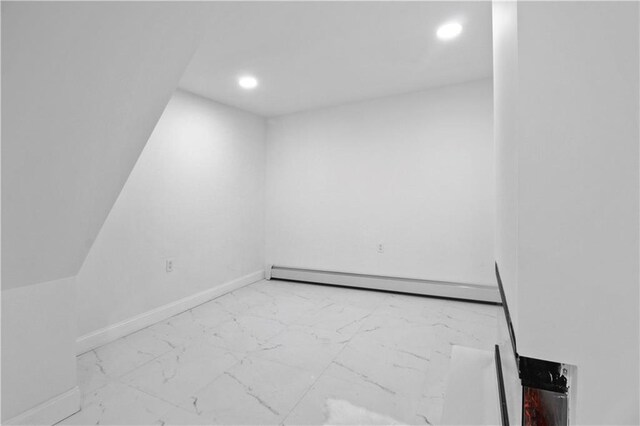 unfurnished room featuring baseboard heating