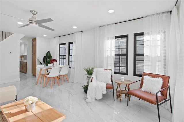 sitting room featuring ceiling fan